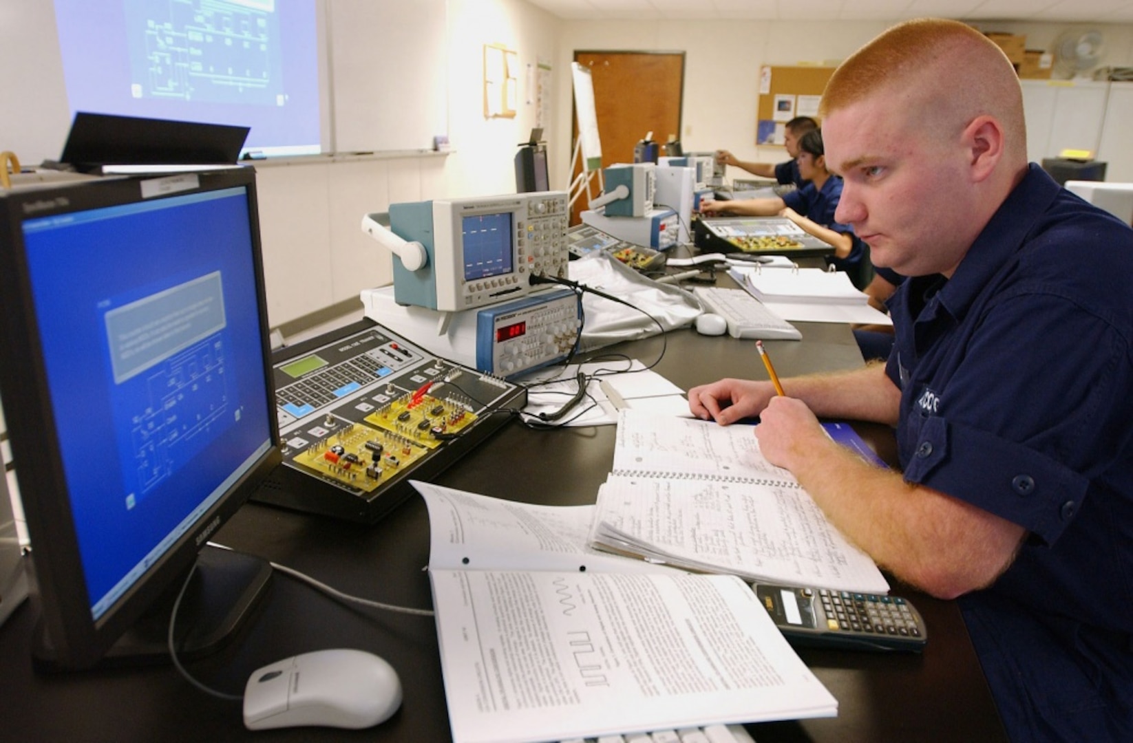 PETALUMA, Calif. (June 23, 2005) An electronics technician (ET) "A" school student at TRACEN Petaluma troubleshoots a circuit board as part of basic electronics training. USCG photo by PA1 Barry Lane.