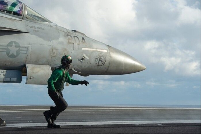 Aviation Boatswain’s Mate (Equipment) 3rd Class Trevor Sollenberger, from Richmond, Va., conducts flight operations aboard the Nimitz-class aircraft carrier USS Dwight D. Eisenhower (CVN-69). Feb. 11, 2021. US Navy Photo