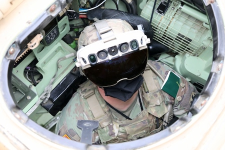 Soldier dons the Integrated Visual Augmentation System Capability Set 3 hardware while mounted on a Bradley in Joint Base Lewis-McCord, WA.