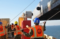 Sailors from Navy Cargo Handling Battalion 1 (NCHB 1) swing literage aboard the USNS 1st LT Jack Lummus (T-AK 3010) during an instream loading exercise.
