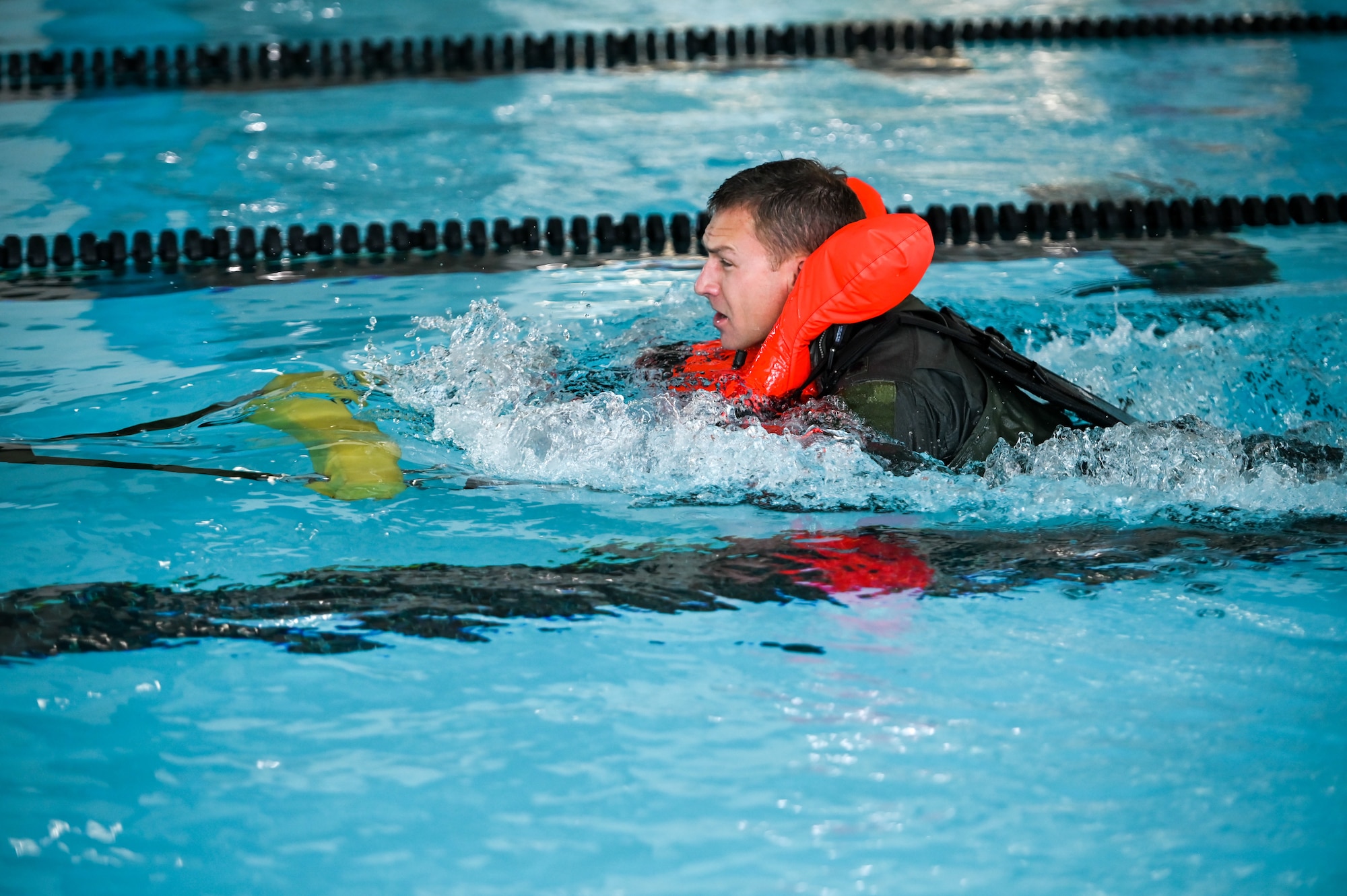 Lt. Col. Bart Wilbanks, an F-35A Lightning II pilot in the 419th Fighter Wing at Hill Air Force Base, Utah, simulates being dragged through the water while still attached to a parachute.