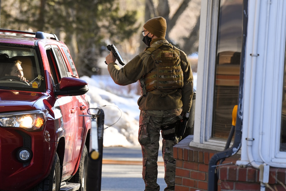 Airman 1st Class Jose Luis, 66th Security Forces Squadron entry controller, checks identifications for personnel entering the installation through the Ruiz Gate at Hanscom Air Force Base, Mass., Feb. 17. The Ruiz Gate (formerly Hartwell Gate) will be open seven days a week from 6 a.m. to 10 p.m. for both inbound and outbound traffic beginning March 1. (U.S. Air Force photo by Mark Herlihy)
