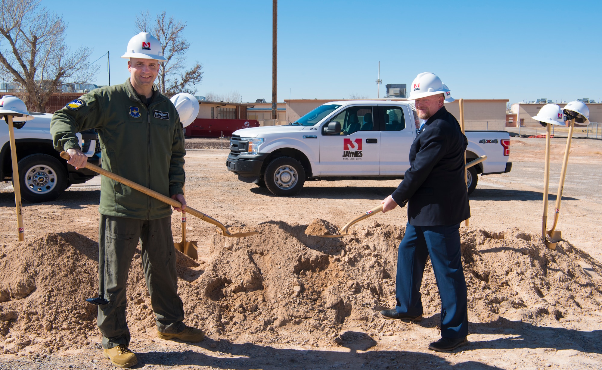Col. Ryan Keeney, left, 49th Wing commander, and Jerrett Perry, Alamogordo Public School District superintendent, shovel dirt during a groundbreaking ceremony, Feb. 19, 2021, on Holloman Air Force Base, New Mexico. The purpose of the overall design of the school is to capture the essence of flight, to honor the men and women who are fighting for our country. (U.S. Air Force photo by Airman 1st Class Jessica Sanchez)