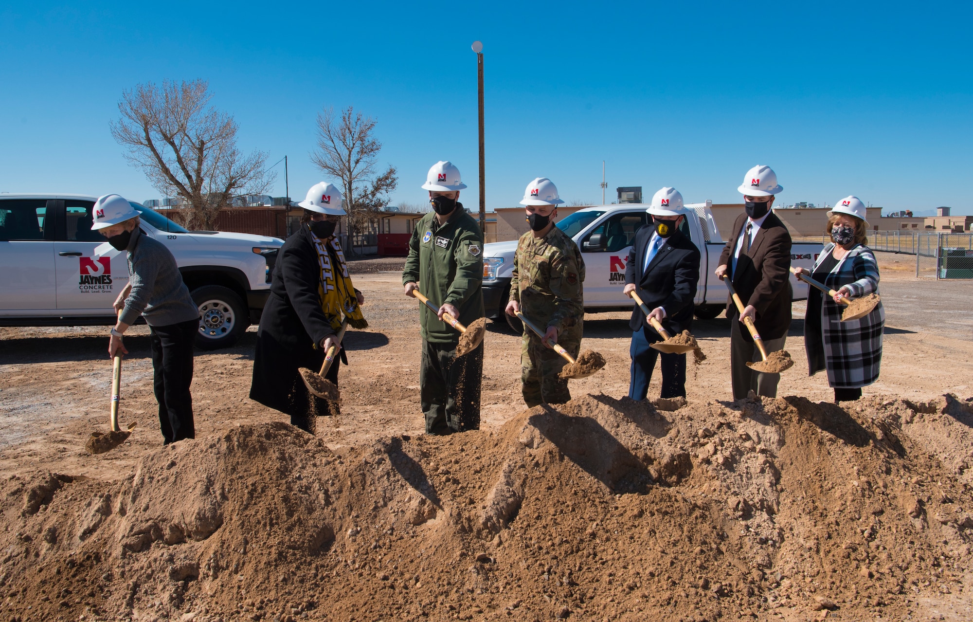 49th Wing leadership and Alamogordo Public School District leadership pose for a photo during the groundbreaking for new school construction, Feb. 19, 2021, on Holloman Air Force Base, New Mexico. The architectural design for the new Holloman Elementary School includes structures that will resemble an air traffic control tower, F-16 Viper contrail, and the roof will resemble aircraft wings. (U.S. Air Force photo by Airman 1st Class Jessica Sanchez)