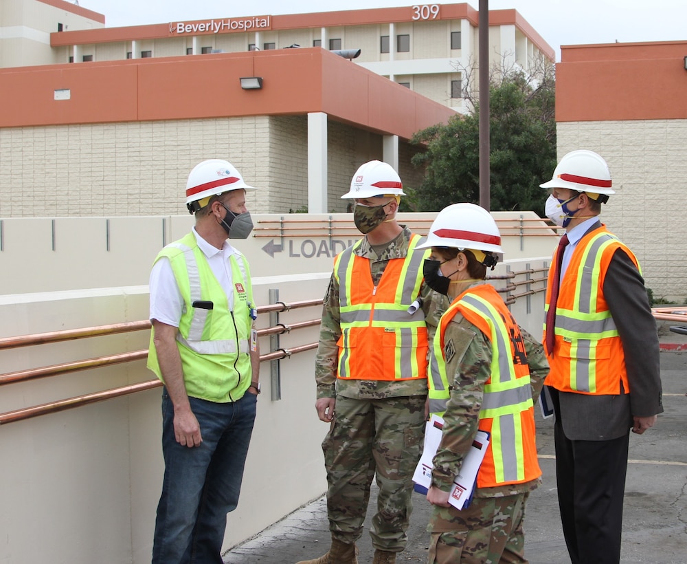 Martin Reed, contracting officer’s representative with the U.S. Army Corps of Engineers Rapid Response Technical Center of Expertise at the Omaha District, left, provides project updates to Brig. Gen. Paul Owen, U.S. Army Corps of Engineers South Pacific Division commander, center, during Owen’s Feb. 9 visit to Beverly Community Hospital in Montebello, California. Accompanying Owen were Col. Julie Balten, Los Angeles District commander, second from right, and David Van Dorpe, LA District deputy engineer.