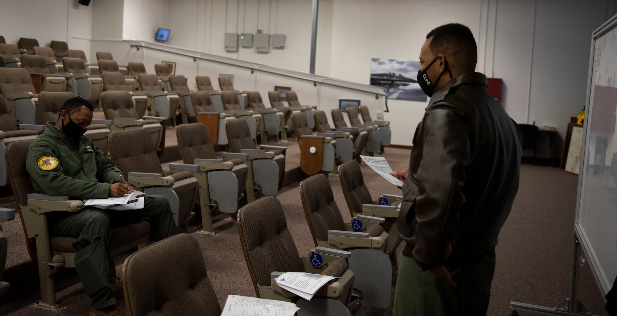 Capt. Michael Craig, left, 311th Fighter Squadron instructor pilot, listens to a pre-flight brief from Capt. Andre Golson, 8th FS IP, Feb. 18, 2021, on Holloman Air Force Base, N.M. In recognition of Black History Month, Craig and Golson teamed up with black pilots from McChord Air Force Base and Fairchild AFB, Washington, to form an all-Black crew during a flight in the local area. (U.S. Air Force photo by Airman 1st Class Quion Lowe)