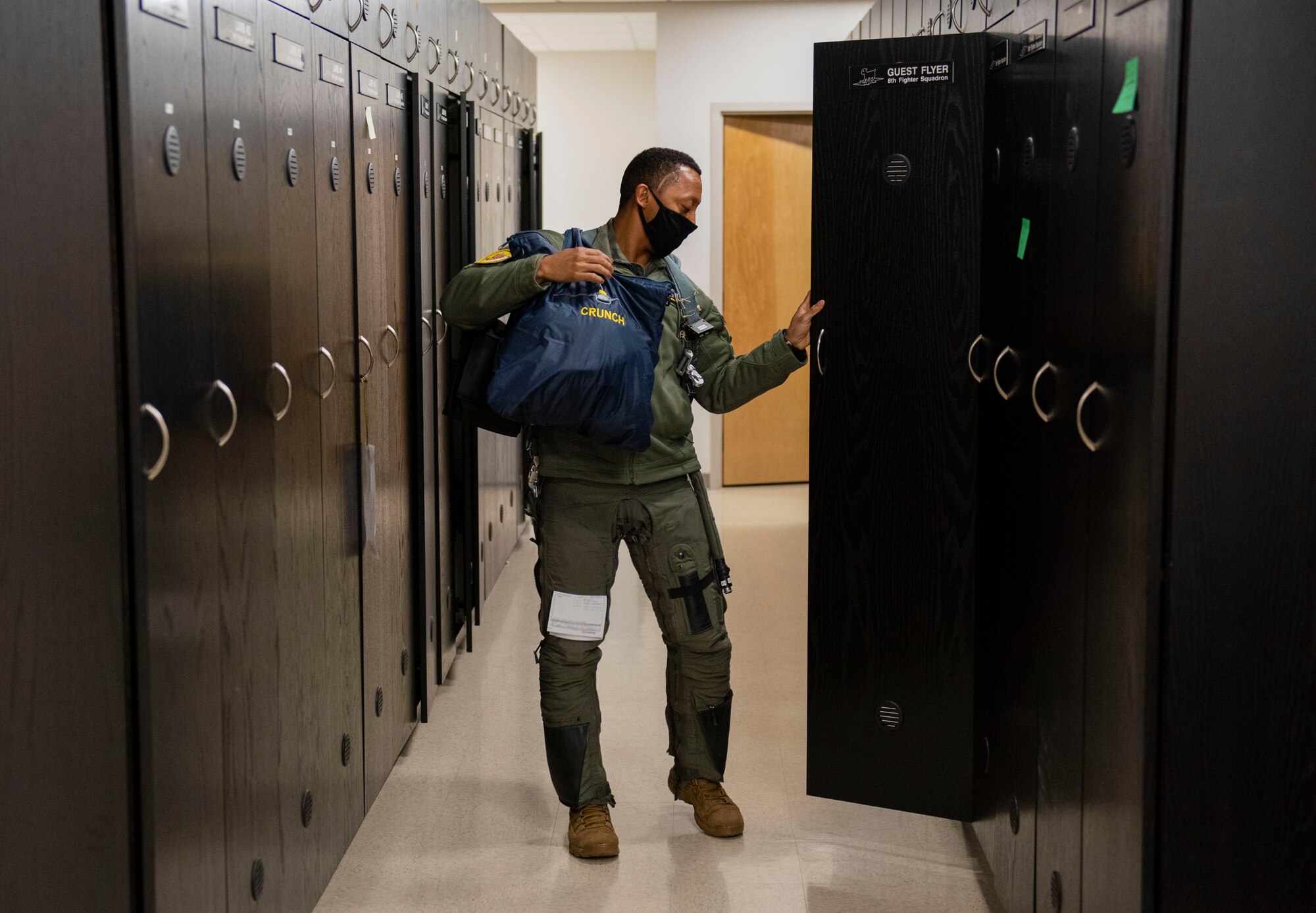 Capt. Michael Craig, 311th Fighter Squadron instructor pilot, puts on a G-suit before a flight, Feb. 18, 2021, on Holloman Air Force Base, N.M. A total of 21 Black Airmen from various Wings across the Air Force integrated F-16, C-17 Globemaster III and KC-135 Stratotanker operations, simulating the training and execution of the Tuskegee Airmen. (U.S. Air Force photo by Airman 1st Class Quion Lowe)