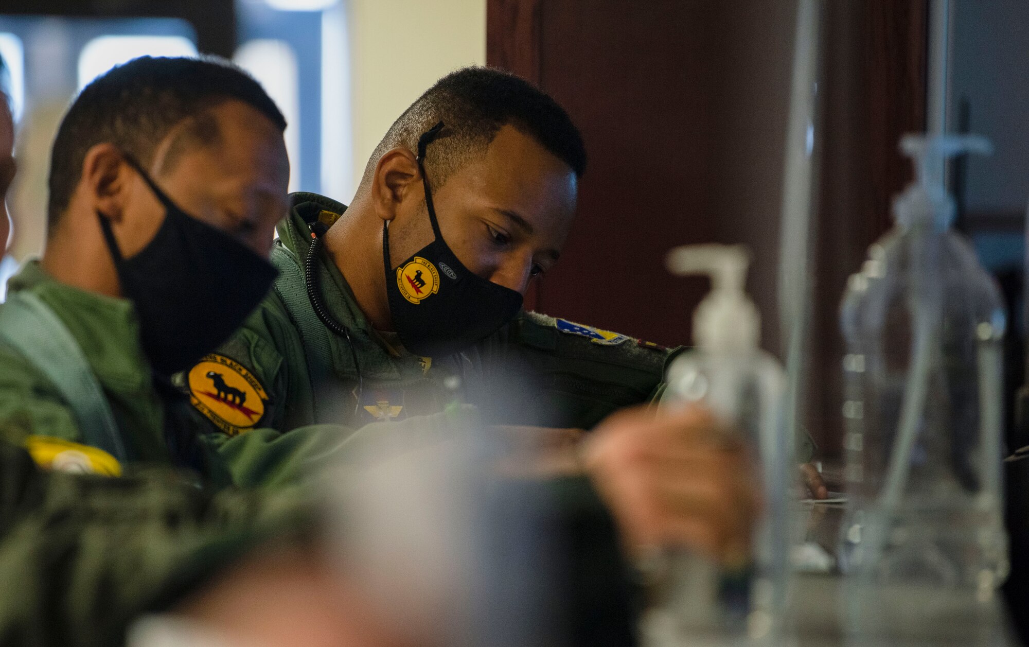 Capt. Michael Craig, left, 311th Fighter Squadron instructor pilot, and Capt. Andre Golson, right, 8th FS IP, are briefed at the step-desk, Feb. 18, 2021, on Holloman Air Force Base, N.M. Two 49th Wing F-16 Viper pilots participated in an all-Black aircrew fly-in. (U.S. Air Force photo by Airman 1st Class Quion Lowe)