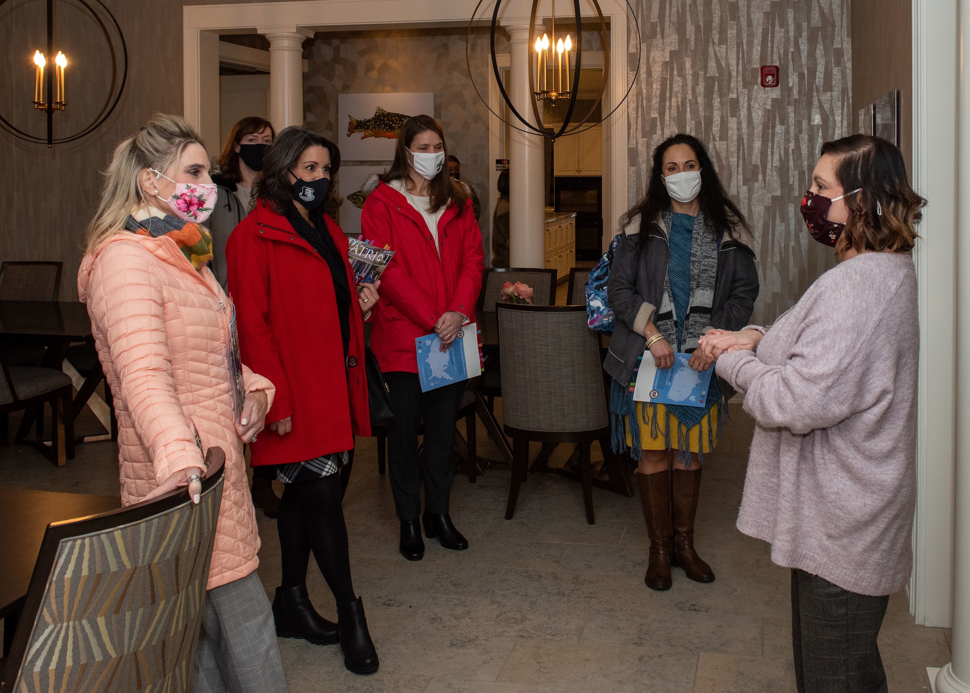 Theresa Nedrow, right, Alaska Fisher House interim manager, briefs Cindy Wilsbach, left, wife of the Pacific Air Forces commander, and other PACAF and Joint Base Elmendorf-Richardson senior leaders’ spouses during a visit to Fisher House II at JBER, Alaska, Feb. 16, 2021. Fisher House II opened in September 2018 and features 16 suites with private bedrooms and baths, and includes a common kitchen, dining room, living room and laundry facilities. Fisher Houses provide free accommodation for families of patients receiving care at major military and Veterans Affairs medical centers.