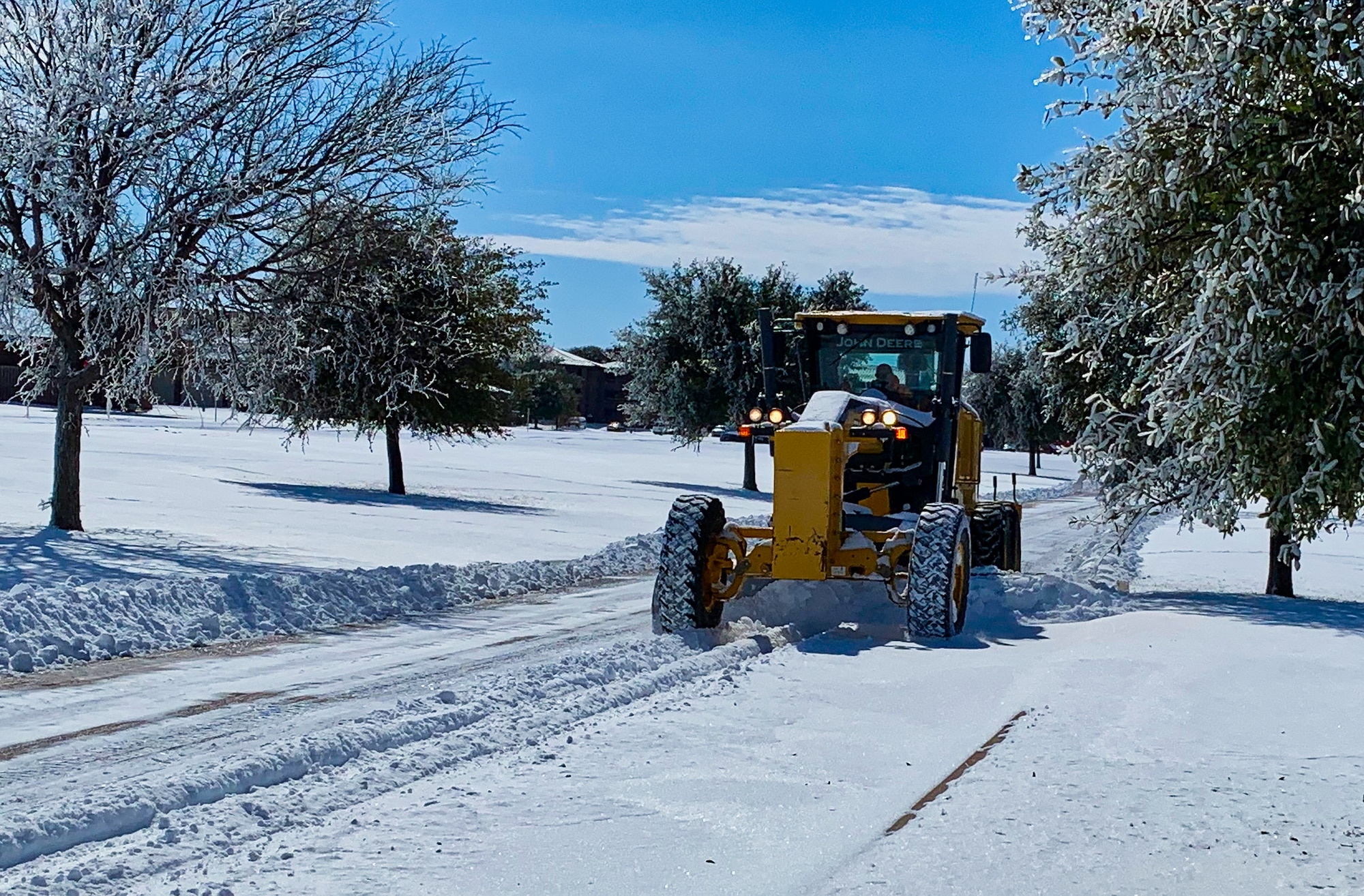 A member of the 17th Civil Engineering Squadron plows the streets throughout Goodfellow Air Force Base, Texas, Feb. 15, 2021. The 17th CES stood up a nine-man team and pieced together every available resource from around the base to tackle the issue of snow removal. (Courtesy photo)