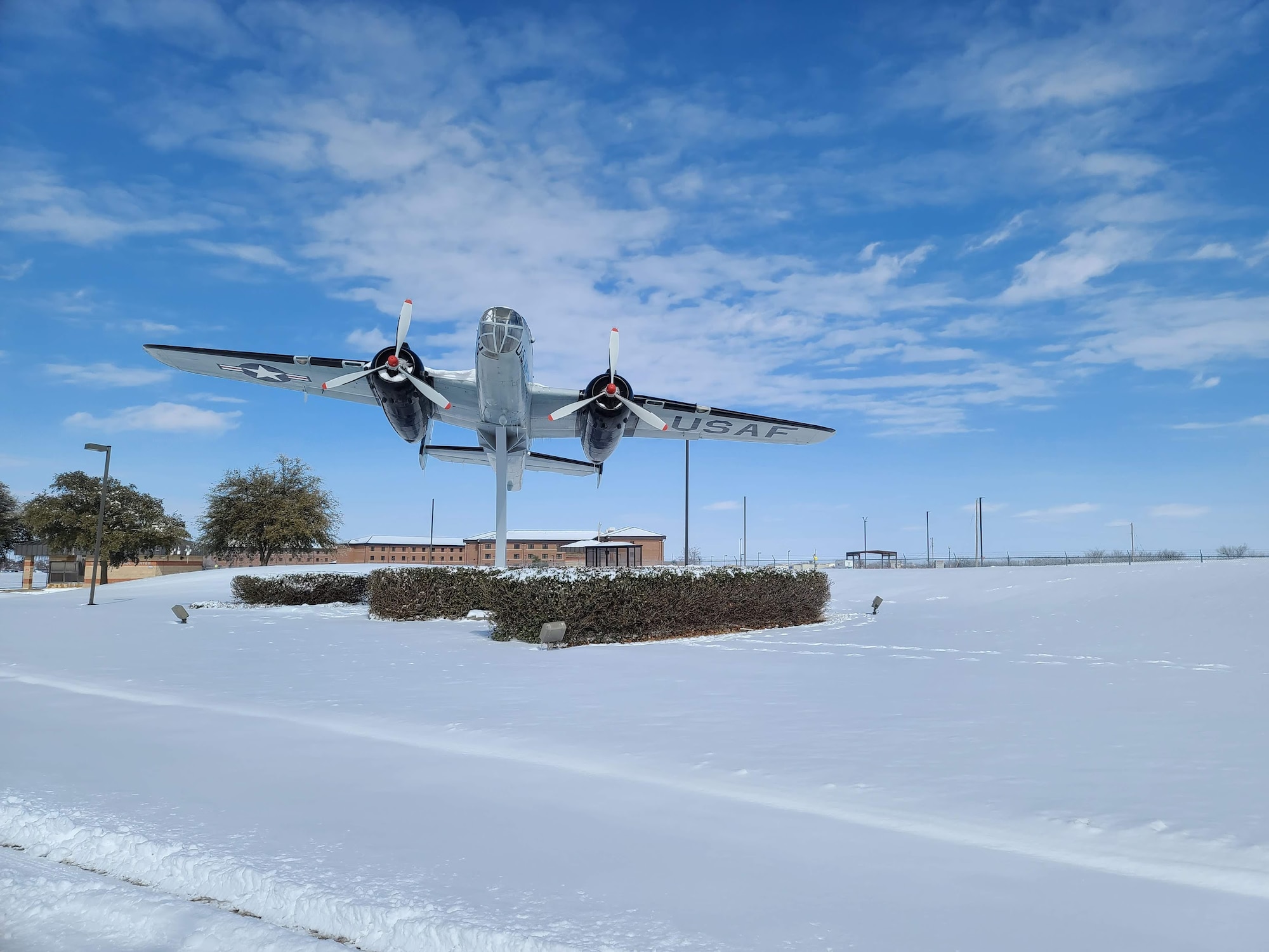 The approach in front of the Jacobson Gate to Goodfellow Air Force Base, Texas, covered in snow, Feb. 15, 2021. The base experienced freezing temperatures and heavy snowfalls in a record-breaking multi-weather phenomenon. (U.S. Air Force photo by Airman 1st Class Michael Bowman)