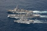 The Arleigh Burke-class guided-missile destroyer USS Curtis Wilbur (DDG 54) conducts a replenishment-at-sea with the Japan Maritime Self-Defense Force Towada-class replenishment ship JS Hamana (AOE 424) and French Floreal-class light frigate FNS Prairial (F731).