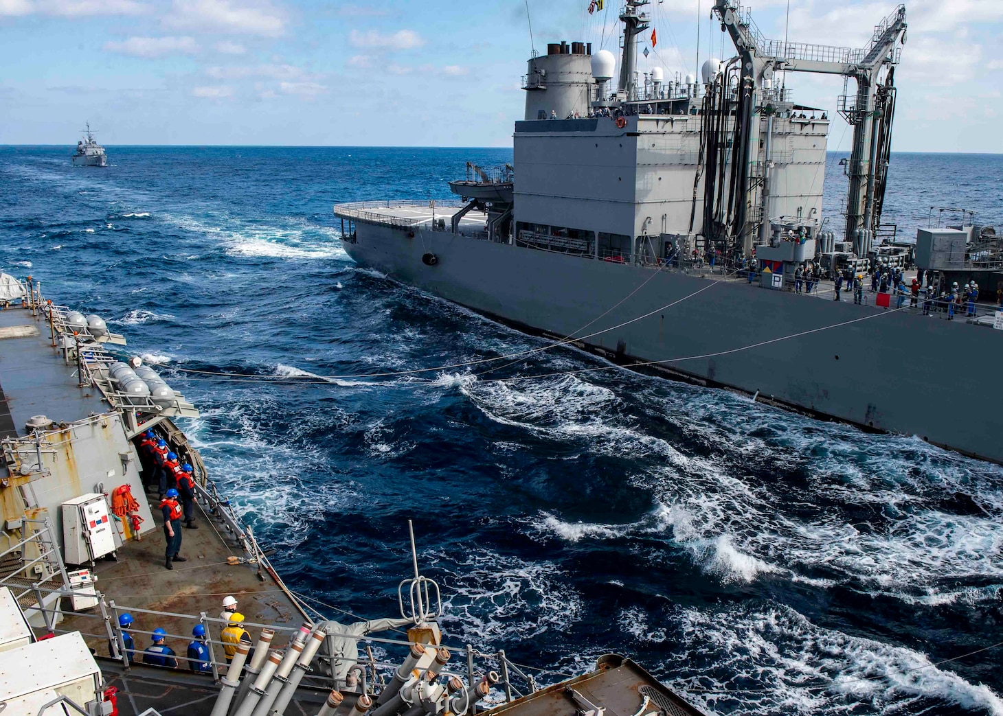 The Arleigh Burke-class guided-missile destroyer USS Curtis Wilbur (DDG 54) conducts a replenishment-at-sea with the Japanese Towada-class replenishment ship JS Hamana (AOE 424) as the Frech Floreal-class light frigate FNS Prairial (F731) prepares to come alongside. Curtis Wilbur is assigned to Destroyer Squadron (DESRON) 15, the Navy's largest forward-deployed DESRON and the U.S. 7th Fleet's principal surface force.