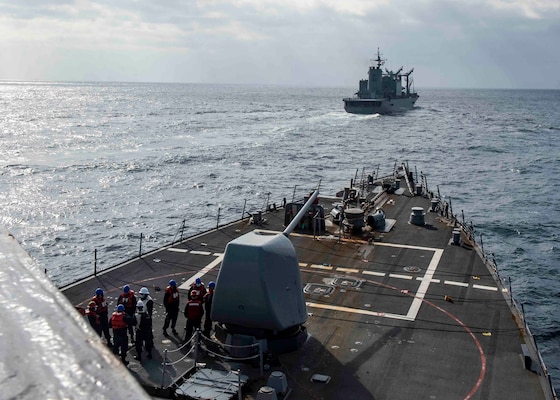 USS Curtis Wilbur (DDG 54) conducts a replenishment-at-sea with the Japan Maritime Self-Defense Force.