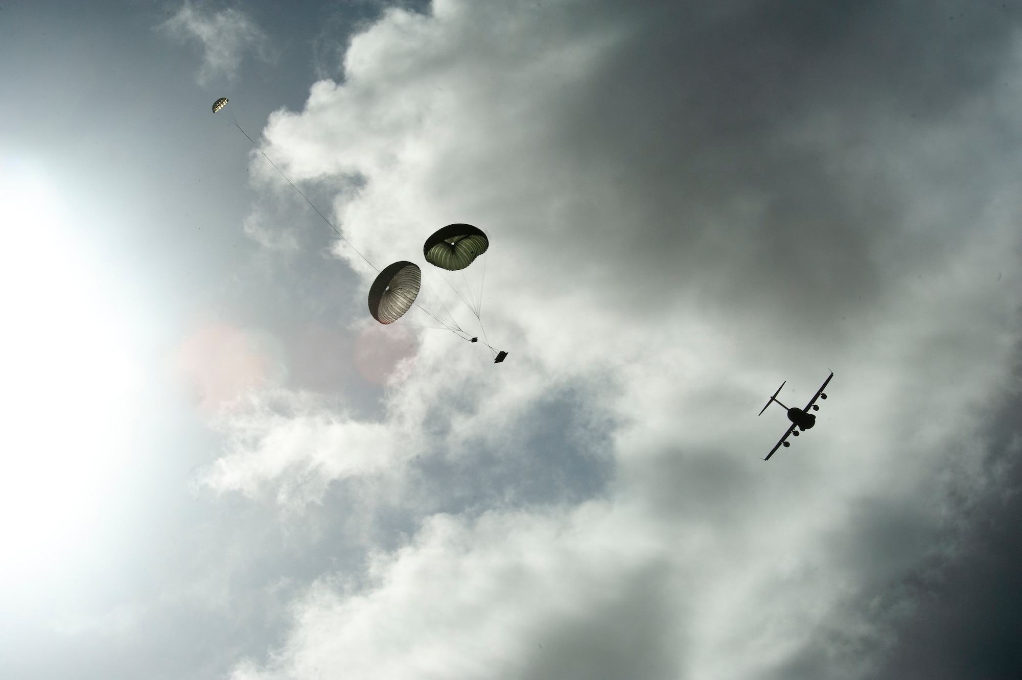 A cargo bundle is airdropped from a Hawaii Air National Guard C-17 Globemaster III during training Jan. 14, 2021, at the Kahuku, Hawaii. The drop was part of exercise H20, focusing on interoperability between Hawaii and Alaska Air National Guard units responsible for contingency astronaut rescue for NASA’s SpaceX Commercial Crew Program.