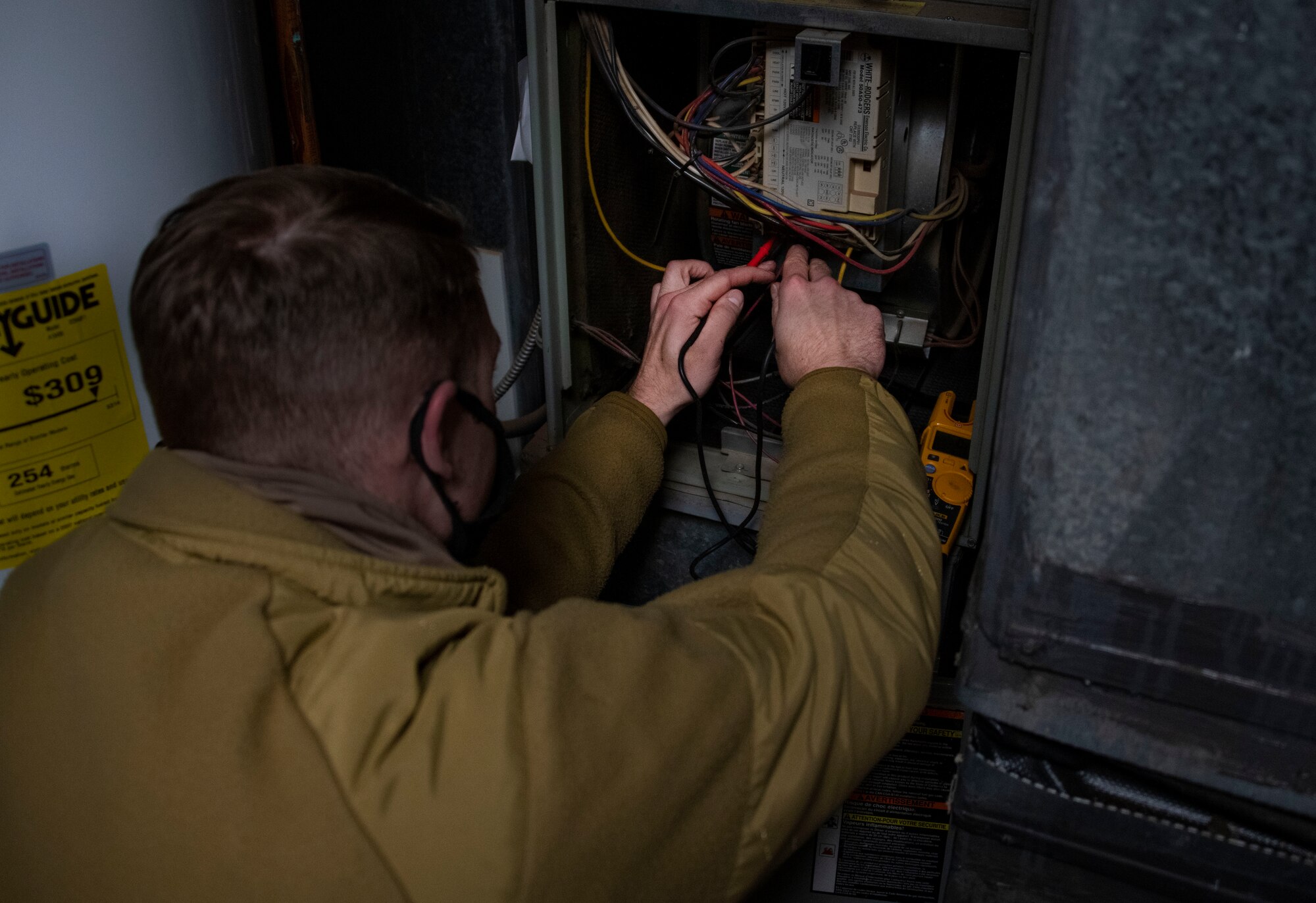 man adjusts wires