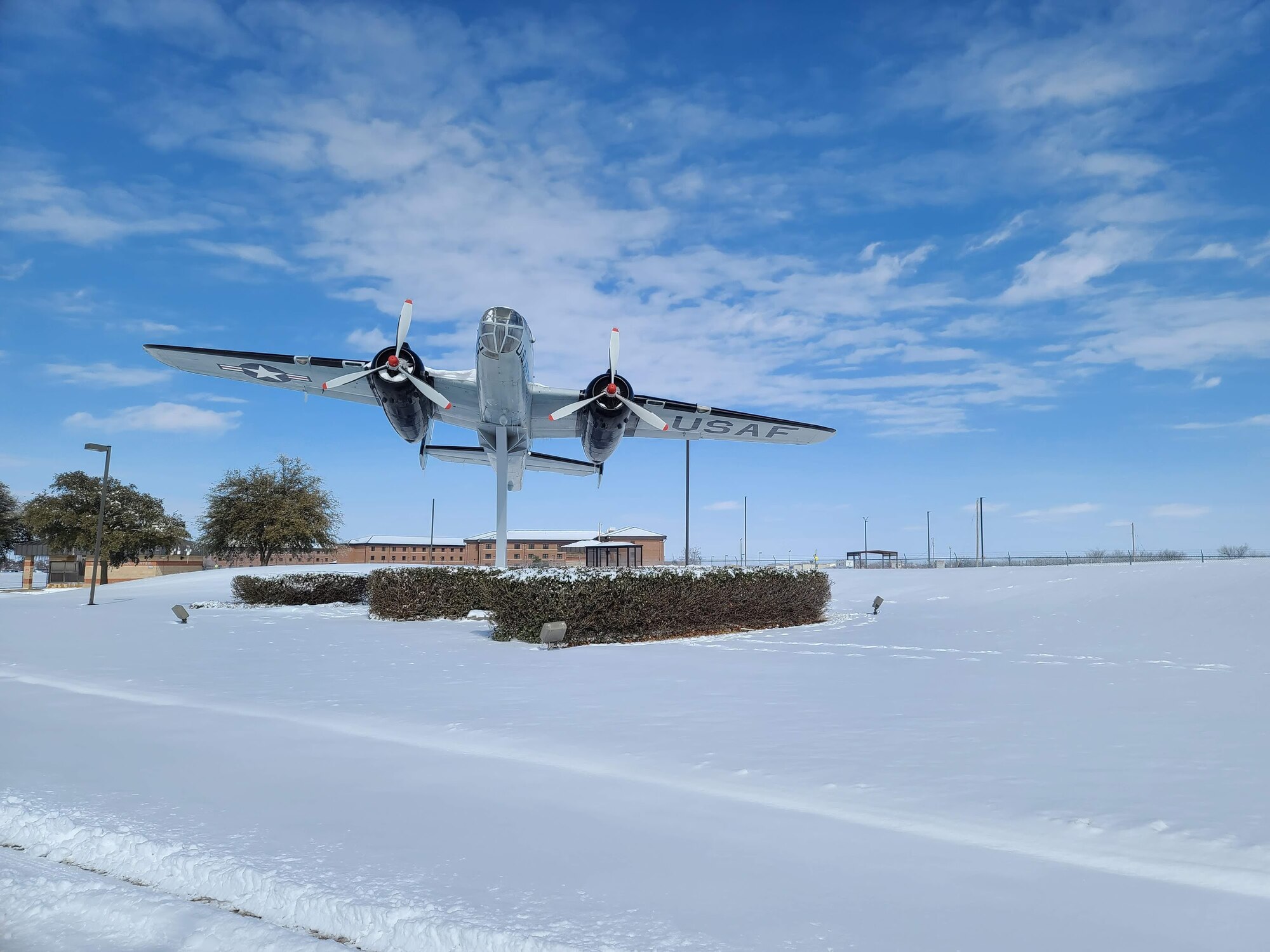The approach in front of the Jacobson Gate to Goodfellow Air Force Base, Texas, covered in snow, Feb. 15, 2021. The base experienced freezing temperatures and heavy snowfalls in a record-breaking multi-weather phenomenon. (U.S. Air Force photo by Airman 1st Class Michael Bowman)