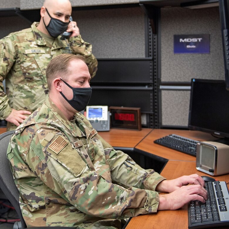 In support of Operation Noble Defender, Master Sgt. Christopher Salch, OL-A operations superintendent, and Master Sgt. Eric Henson, OL-A communications flight chief, simulate space electronic intelligence threats and provide combat survivor evader locator data from Schriever Air Force Base, Colorado, directly to the cockpits of airborne HH-60G Pave Hawk’s and HC-130J Combat King II’s flying from Joint Base Elemendorf-Richardson, Alaska. Operation Noble Defender is a North American Air Defense Command air-defense operation that allows dynamic training for operational readiness in an Arctic environment. (U.S. Space Force photo by Judi Tomich)