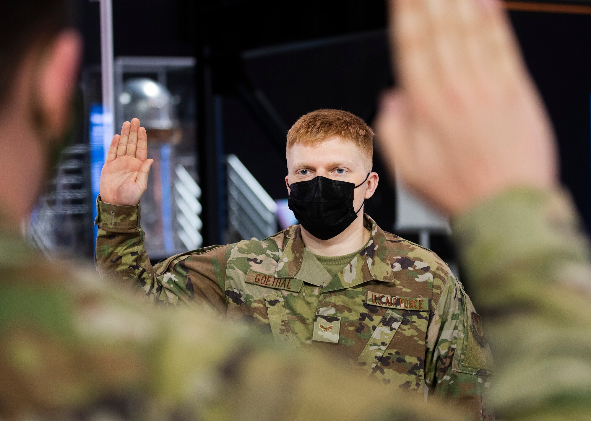Airman 1st Class Noah Goethal, 88th Communications Squadron, takes the oath of enlistment on Feb. 11, becoming a Space Force specialist 3 during a ceremony in the National Museum of the U.S. Air Force. New Space Force 1st Lt. Kyle McReynolds, also of 88 CS, administered the oath shortly after being sworn in himself. (U.S. Air Force photo by R.J. Oriez)