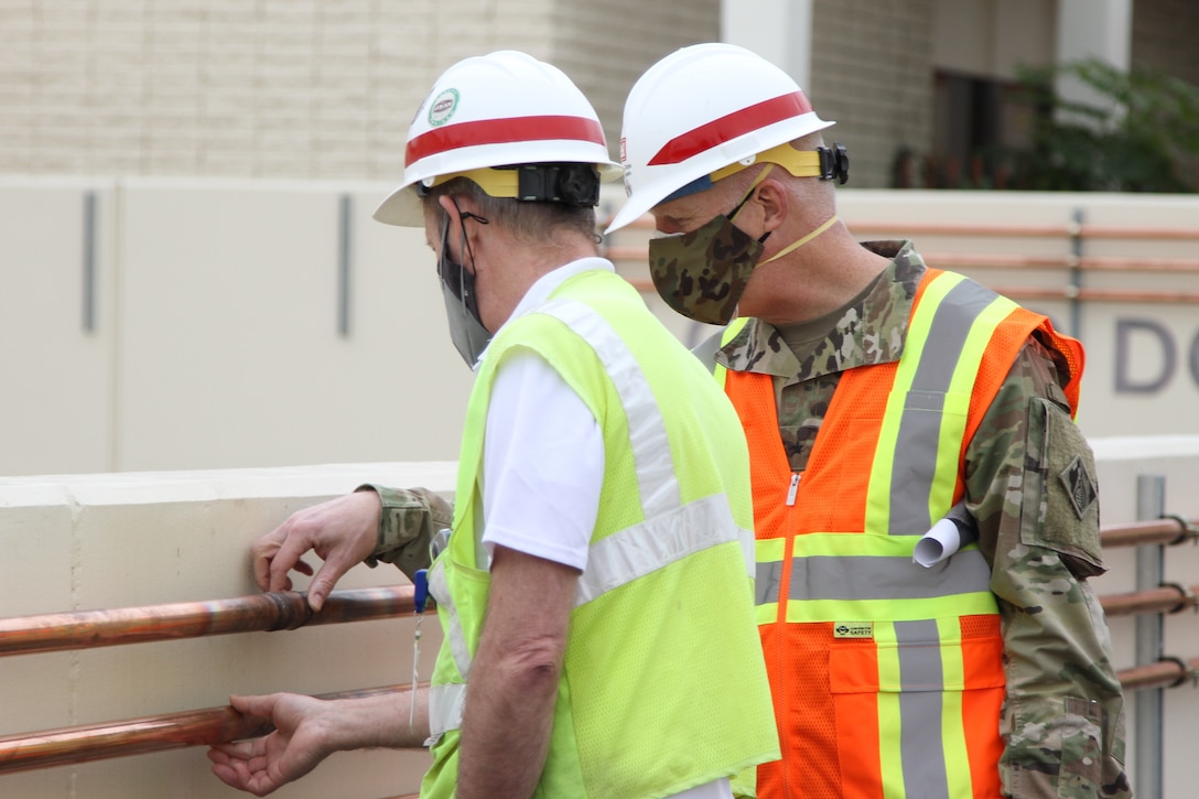 During his Feb. 9 visit to Beverly Community Hospital in Montebello, California, Brig. Gen. Paul Owen, U.S. Army Corps of Engineers South Pacific Division commander, right, joins Martin Reed, contracting officer’s representative with the U.S. Army Corps of Engineers Rapid Response Technical Center of Expertise at the Omaha District, to examine newly installed copper tubing designed to safely transport specialized medical-grade gas mixtures for hospital patients.