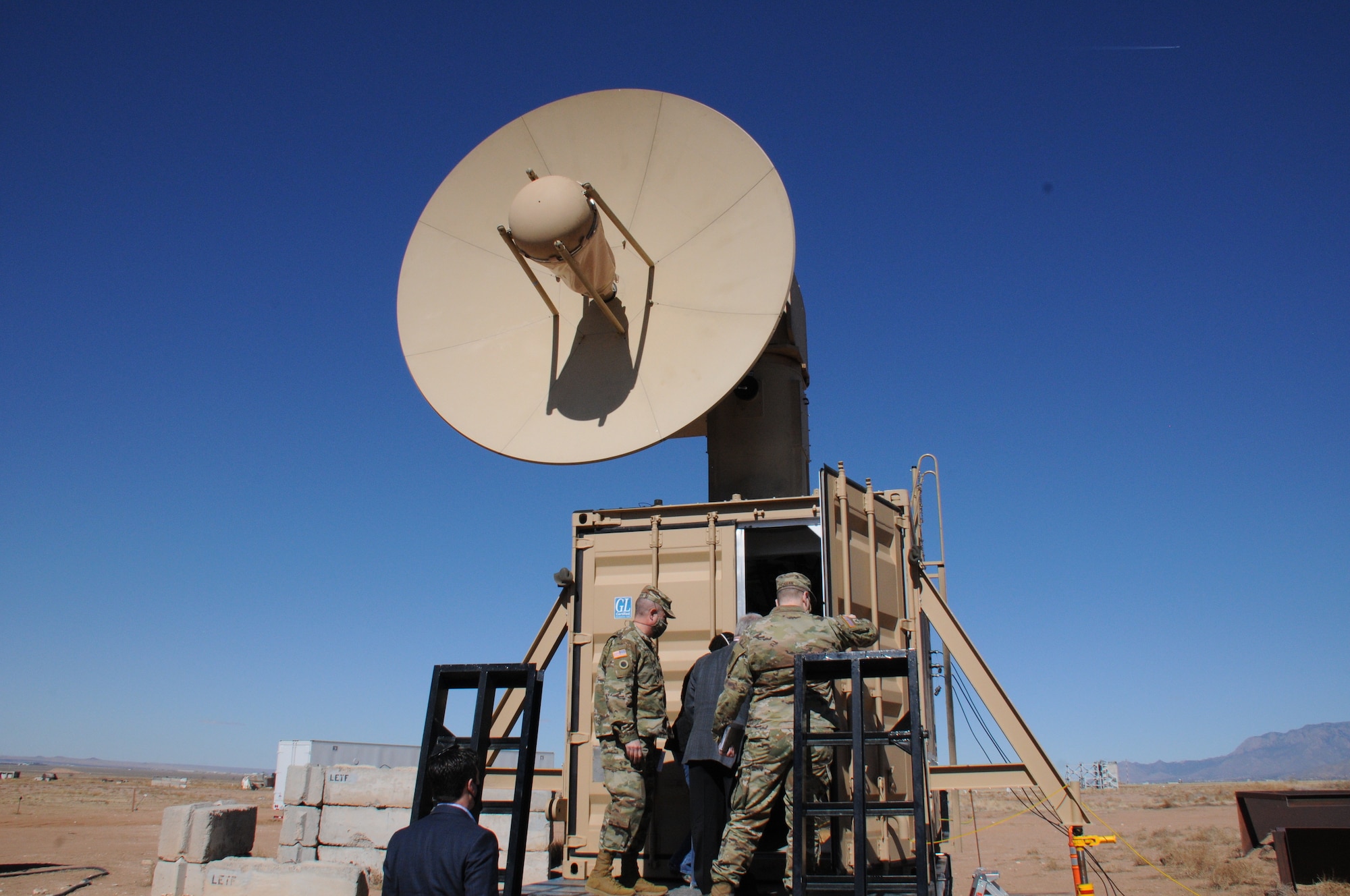 Military members tour and view directed energy technology