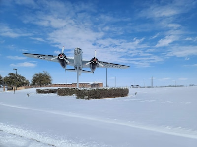 The approach in front of the Jacobson Gate to Goodfellow Air Force Base, Texas, covered in snow, Feb. 15, 2021. The base experienced freezing temperatures and heavy snowfalls in a record-breaking multi-weather phenomenon. (U.S. Air Force photo by Airman 1st Class Michael Bowman)