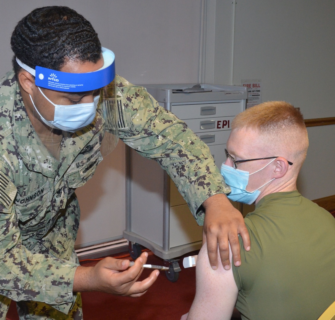 A service member gets a vaccination.