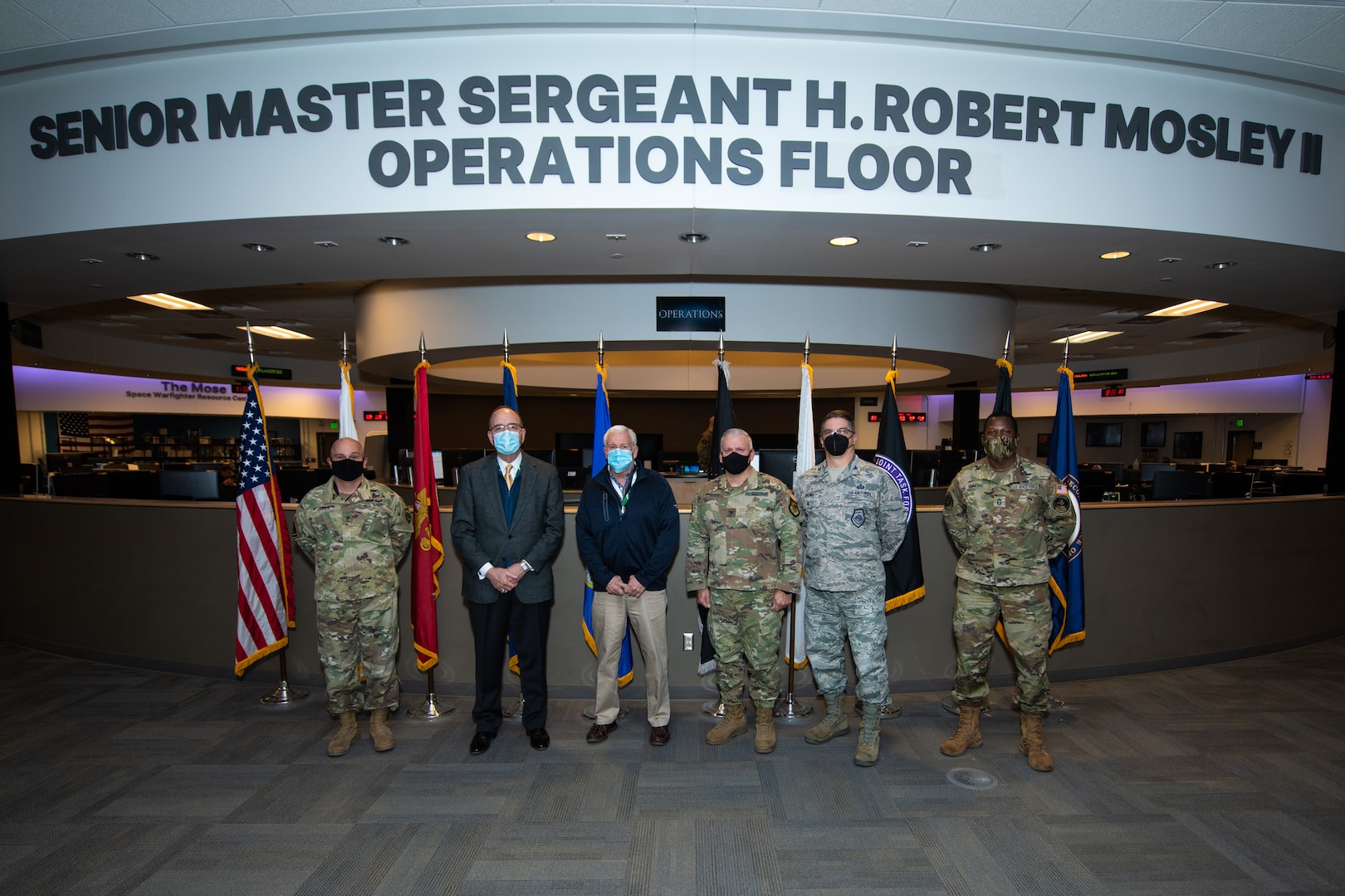 Senior leaders gather on the National Space Defense Center operations floor during a visit to learn more about the organization's mission.