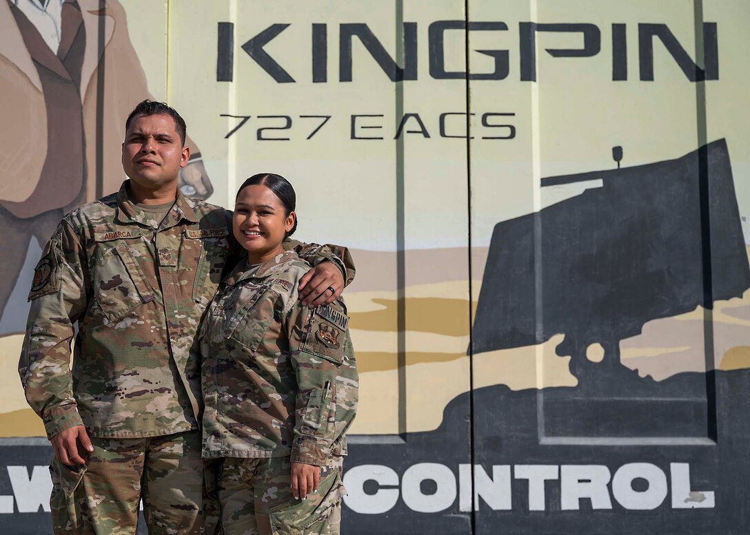 U.S. Air Force Staff Sgt. Sergio Abarca (left) and Staff Sgt. Regina Abarca (right), both 727th Expeditionary Air Control Squadron weapons directors, pose for a photo at Al Dhafra Air Base (ADAB), United Arab Emirates, Jan 21, 2021.