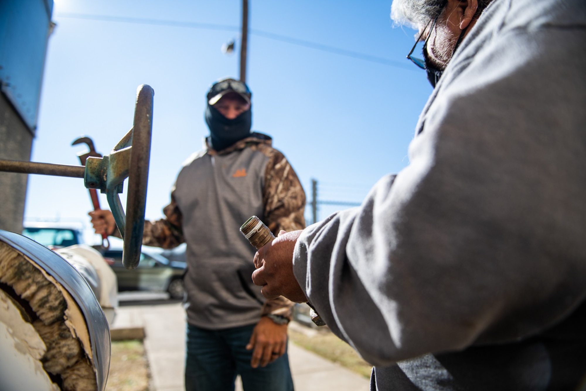 Eric Wheatley (left), and Joe Hinojosa (right), 502nd Civil Engineer Squadron heating, ventilation, and air condition technicians, report to damages caused by the severe winter storm lasting over five days, Feb. 19, 2021, at Joint Base San Antonio-Lackland, Texas.