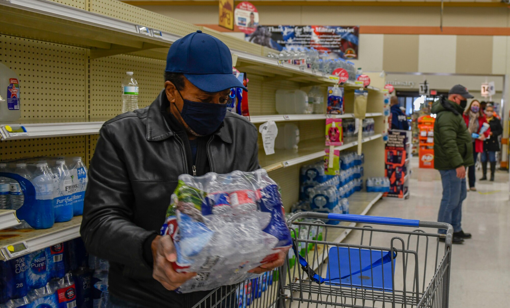 A commissary patron puts water in his cart at the Joint Base San Antonio-Randoph Commissary Feb. 19, 2021.