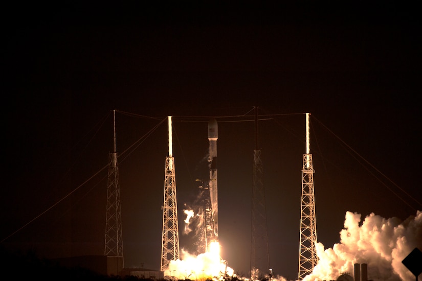 A rocket launches into the night sky.