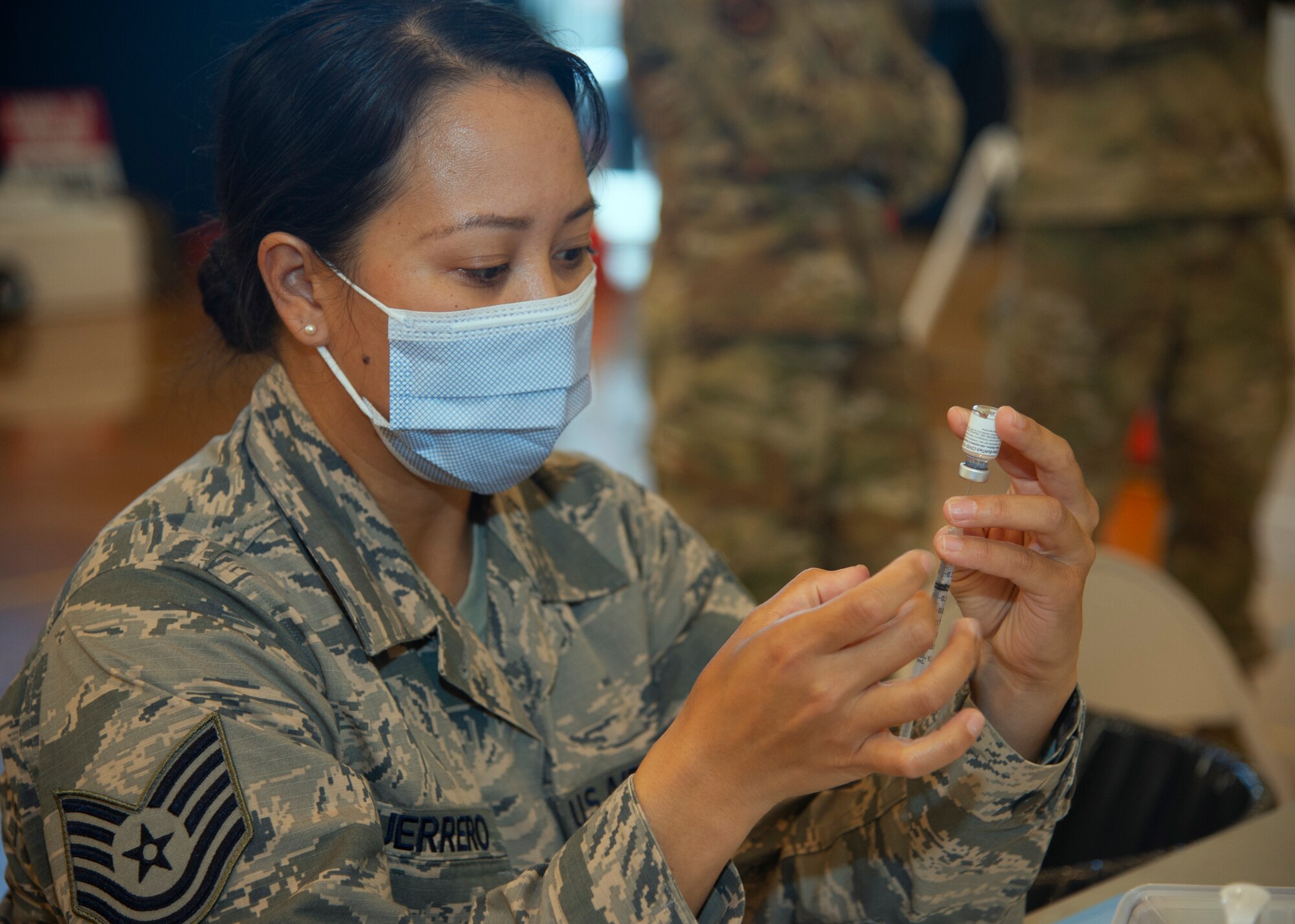 U.S. Air Force Tech. Sgt. Shannon Guerrero, 624th Aeromedical Staging Squadron (ASTS) medical technician, prepares a COVID-19 vaccine needle at a temporary vaccination site at Hickam Memorial Fitness Center on Joint Base Pearl Harbor-Hickam, Hawaii, Jan. 22, 2021.
