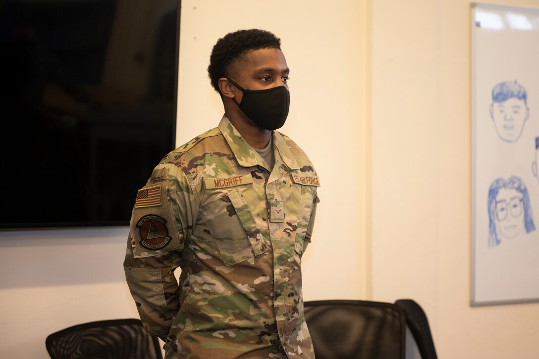 U.S. Air Force Airman 1st Class Isaiah McGriff, 423rd Force Support Squadron postal directory clerk, receives recognition from Chief Master Sgt. Daniel Keene, 501st Combat Support Wing command chief, as the January Pathfinder Grit Award winner, at Royal Air Force Alconbury, England, Feb. 19, 2021. McGriff received the award for his high performance as a postal directory clerk, as well as the additional duties of being a voting representative for the RAF Alconbury and RAF Molesworth Post Offices. McGriff led the Secretary of Defense’s high visibility program by processing over 1,000 absentee ballots, which ensured members the right to vote in the 2020 Presidential Election. (U.S. Air Force photo by Senior Airman Jennifer Zima)