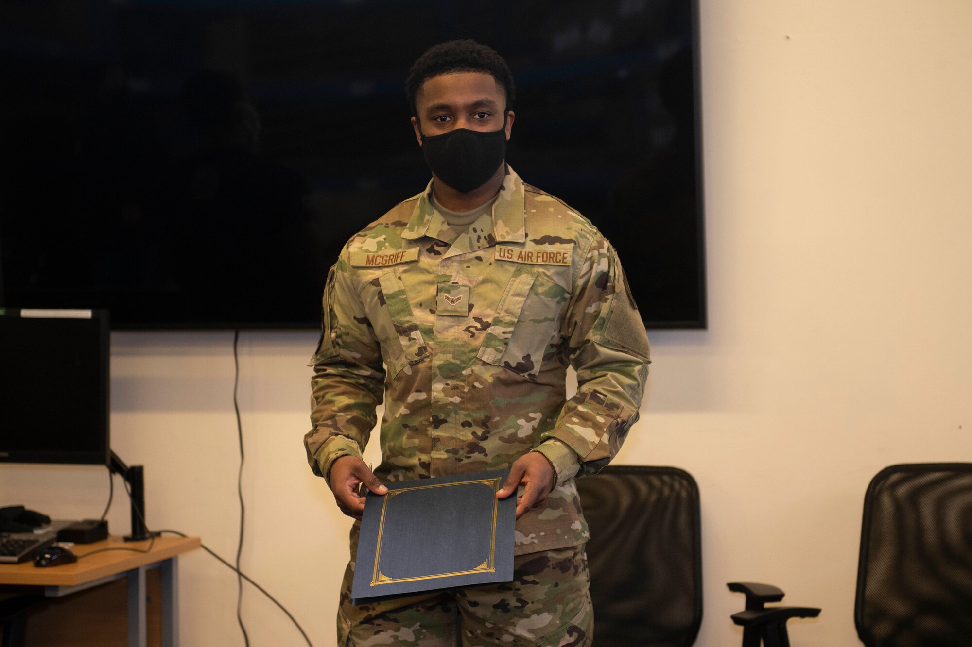 U.S. Air Force Airman 1st Class Isaiah McGriff, 423rd Force Support Squadron postal directory clerk, receives recognition from Chief Master Sgt. Daniel Keene, 501st Combat Support Wing command chief, as the January Pathfinder Grit Award winner, at Royal Air Force Alconbury, England, Feb. 19, 2021. McGriff received the award for his high performance as a postal directory clerk, as well as the additional duties of being a voting representative for the RAF Alconbury and RAF Molesworth Post Offices. McGriff led the Secretary of Defense’s high visibility program by processing over 1,000 absentee ballots, which ensured members the right to vote in the 2020 Presidential Election. (U.S. Air Force photo by Senior Airman Jennifer Zima)