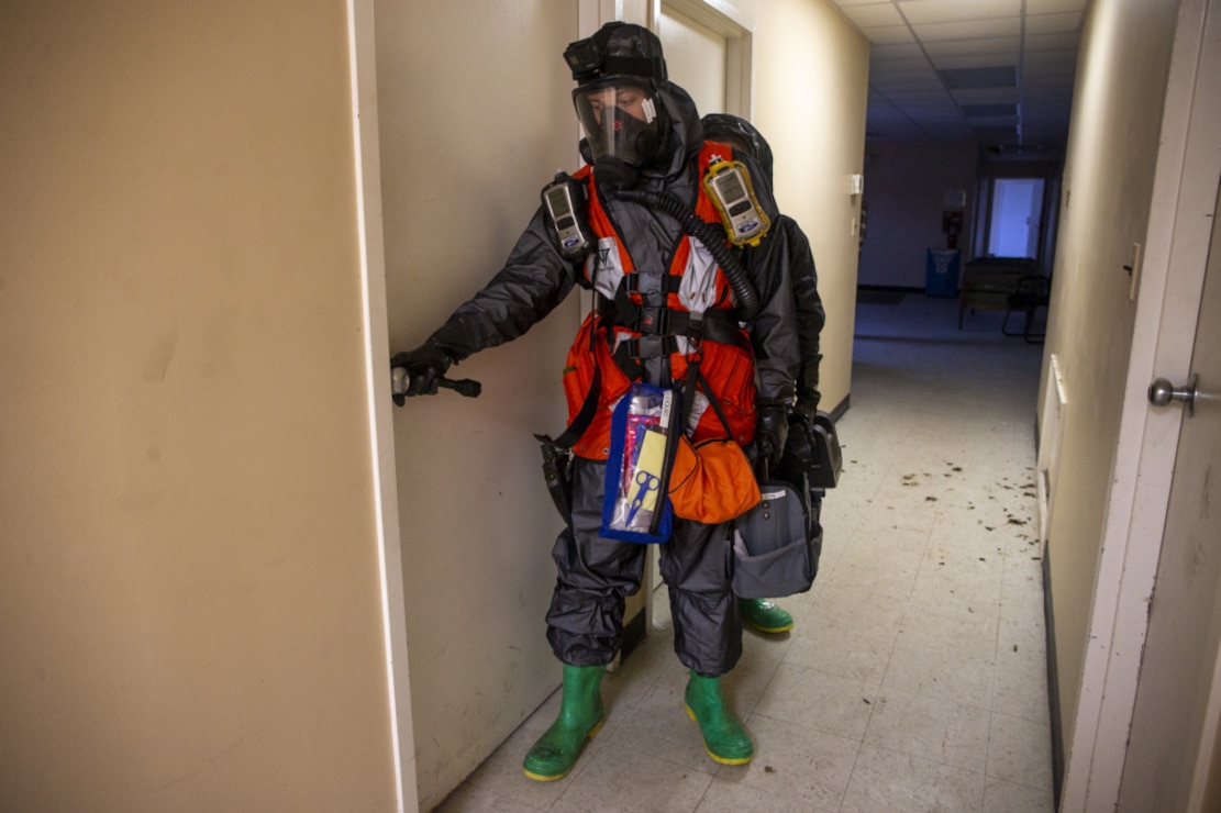 U.S. Marine Corps Lance Cpl. Connor Russell, front, and Cpl. Brandon Lloyd, both chemical, biological, radiological, and nuclear (CBRN) defense specialists with Headquarters Battalion, 2d Marine Division, enter a room during a hazardous biological lab scenario on Camp Lejeune, N.C., Feb. 18, 2021. The scenario tested the ability of the Marine to respond to a hazardous environment and properly identify, handle, and dispose of hazardous material and waste. (U.S. Marine Corps photo by Pfc. Sarah Hediger)