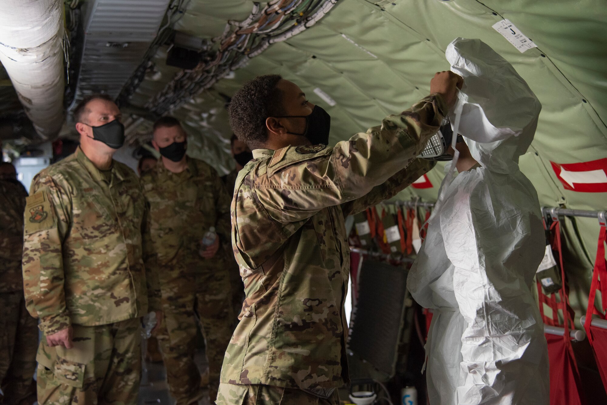 U.S. Air Force Maj. Gen. Thad Bibb Jr., 18th Air Force commander and Chief Master Sgt. Chad Bickley, 18th Air Force command chief look on as members of the 6th Maintenance Squadron prepare to conduct a decontamination demonstration in a KC-135 Stratotanker aircraft, Feb. 18, 2021 at MacDill Air Force Base, Fla.