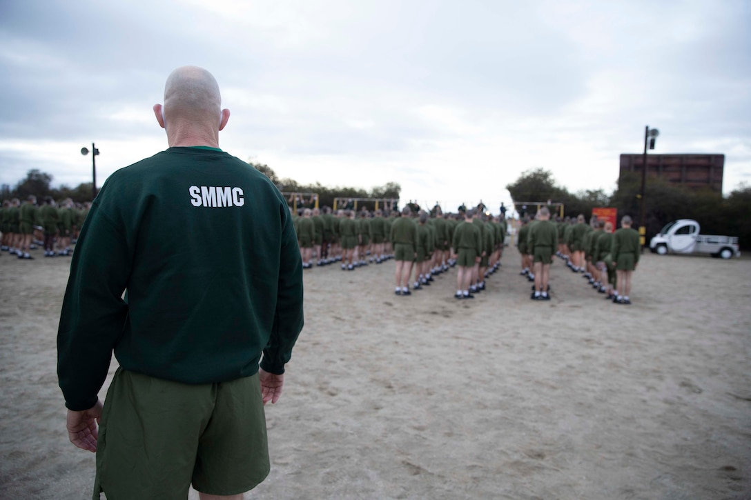 The 19th Sergeant Major of the Marine Corps, Sgt. Maj. Troy E. Black, observes the initial fitness test of the first gender integrated company at Marine Corps Recruit Depot San Diego, Ca, Feb. 12, 2021. The Sergeant Major of the Marine Corps conducted the visit to observe the integrated training and to speak to Depot staff. The Depot's primary function is to take quality young men and women from the western two-thirds of the United States and transform them through the foundations of rigorous basic training, our shared legacy, and a commitment to our Core Values, preparing them to win our Nation’s battles in service to the country. (U.S. Marine Corps photo by Sgt. Victoria Ross)