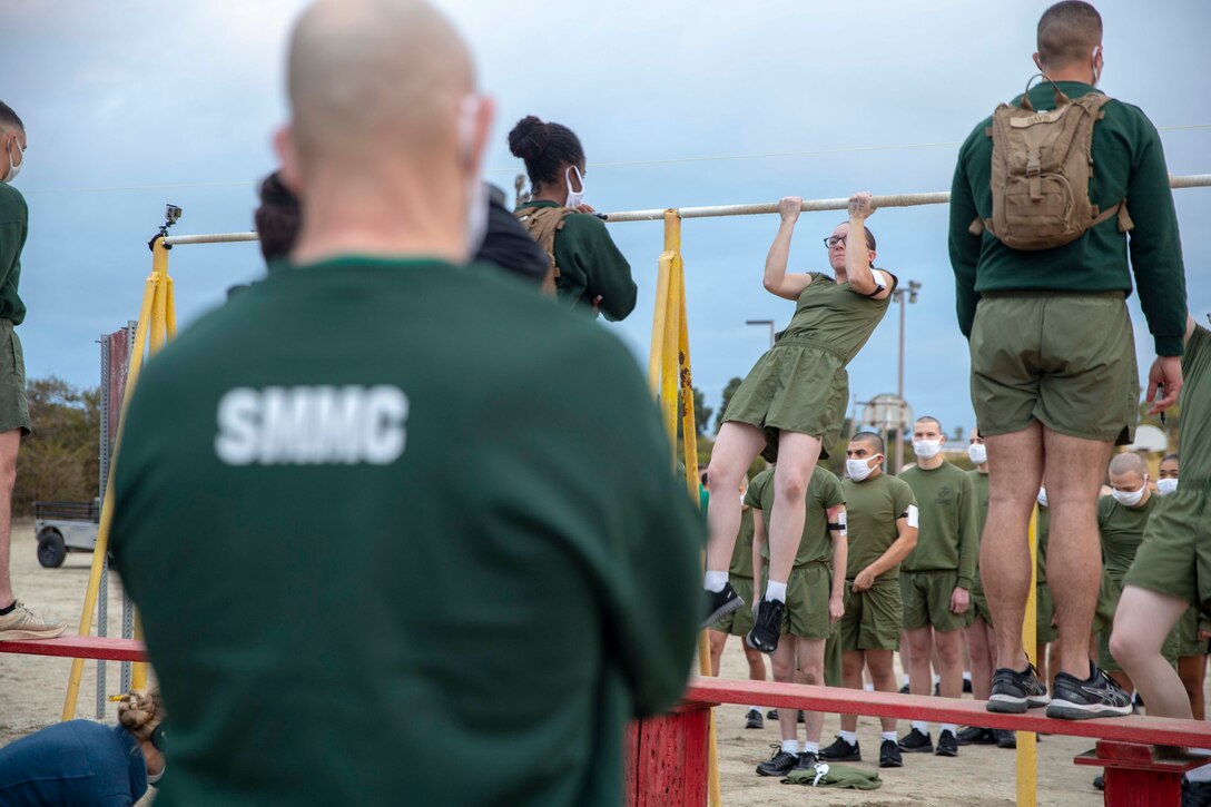 The 19th Sergeant Major of the Marine Corps, Sgt. Maj. Troy E. Black, observes the initial fitness test of the first gender integrated company at Marine Corps Recruit Depot San Diego, Ca, Feb. 12, 2021. The Sergeant Major of the Marine Corps conducted the visit to observe the integrated training and to speak to Depot staff. The Depot's primary function is to take quality young men and women from the western two-thirds of the United States and transform them through the foundations of rigorous basic training, our shared legacy, and a commitment to our Core Values, preparing them to win our Nation’s battles in service to the country. (U.S. Marine Corps photo by Sgt. Victoria Ross)