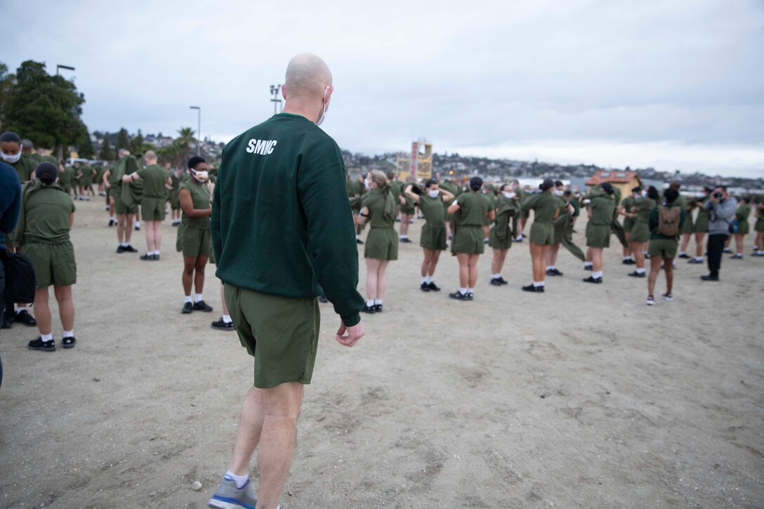 The 19th Sergeant Major of the Marine Corps, Sgt. Maj. Troy E. Black, observes the initial fitness test of the first gender integrated company at Marine Corps Recruit Depot San Diego, Ca, Feb. 12, 2021. The Sergeant Major of the Marine Corps conducted the visit to observe the integrated training and to speak to Depot staff. The Depot's primary function is to take quality young men and women from the western two-thirds of the United States and transform them through the foundations of rigorous basic training, our shared legacy, and a commitment to our Core Values, preparing them to win our Nation’s battles in service to the country. (U.S. Marine Corps photo by Sgt. Victoria Ross)