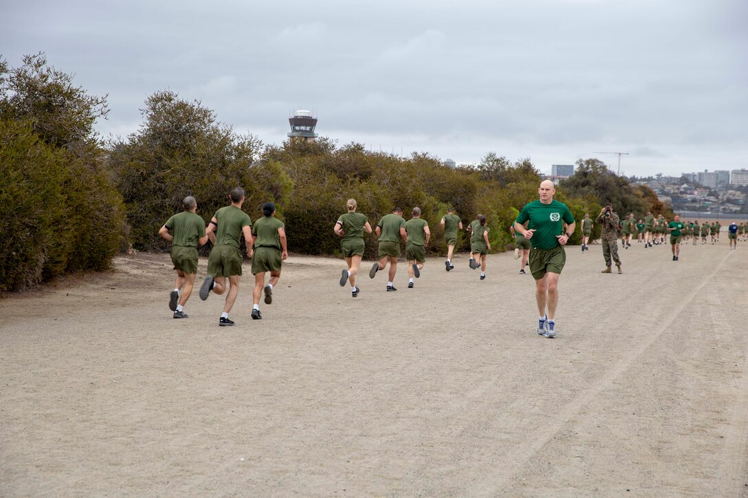 The 19th Sergeant Major of the Marine Corps, Sgt. Maj. Troy E. Black, observes the initial fitness test of the first gender integrated company at Marine Corps Recruit Depot San Diego, Ca, Feb. 12, 2021. The Sergeant Major of the Marine Corps conducted the visit to observe the integrated training and to speak to Depot staff. The Depot's primary function is to take quality young men and women from the western two-thirds of the United States and transform them through the foundations of rigorous basic training, our shared legacy, and a commitment to our Core Values, preparing them to win our Nation’s battles in service to the country. (U.S. Marine Corps photo by Sgt. Victoria Ross)