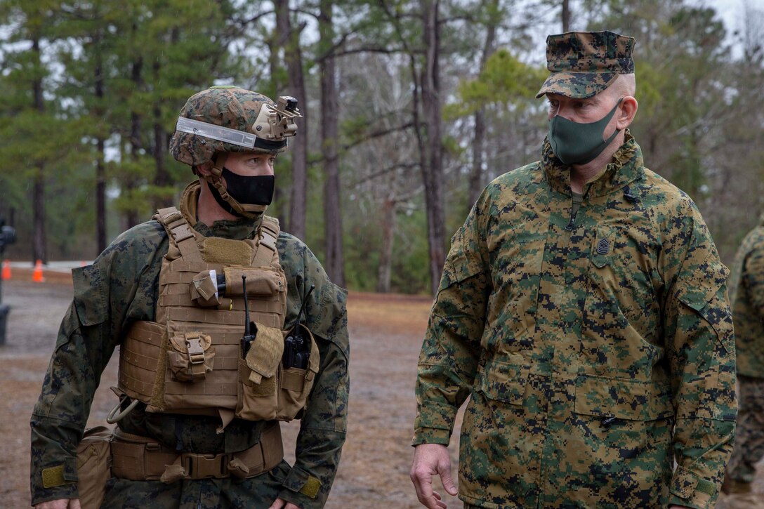 The 19th Sergeant Major of the Marine Corps, Sgt. Maj. Troy E. Black, speaks to a Basic Infantry Course instructor at Marine Corps Base Camp Lejeune, Nc, Feb. 18, 2021. The Sergeant Major of the Marine Corps conducted the visit to see how the current period of instruction is being taught at School of Infantry East. The mission of Infantry Training Battalion is to train and qualify Marines in entry-level infantry military occupational specialties in order to provide the Operating Forces and Reserve Component with Marines capable of conducting expeditionary combat operations. (U.S. Marine Corps photo by Sgt. Victoria Ross)