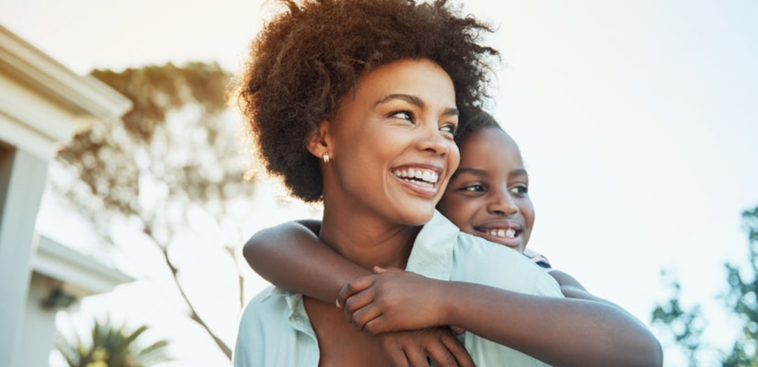 Black women with her son on her back.