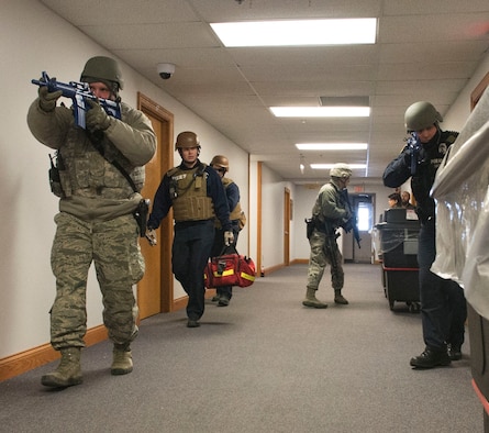 Wright-Patterson AFB Security Forces and emergency-response personnel enter a base facility during a February 2015 active-shooter exercise. Active-shooter response is the focus of a base-wide exercise Feb. 24. (U.S. Air Force photo/Wesley Farnsworth)