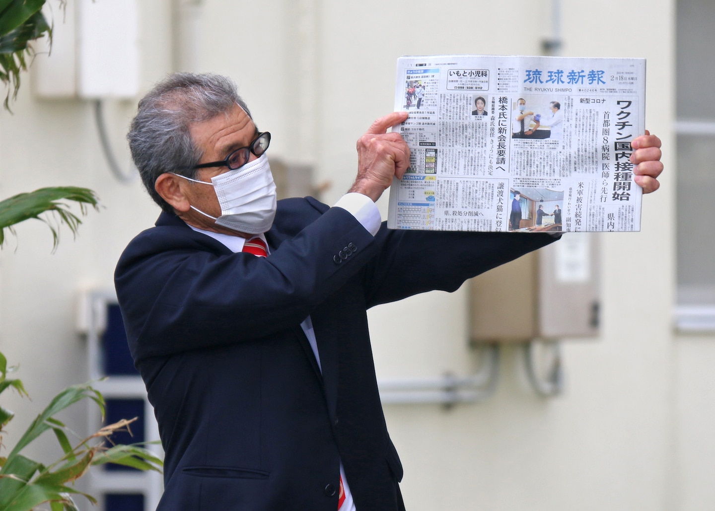 Tsutomu Nakasone shows off an item being placed in a time capsule.