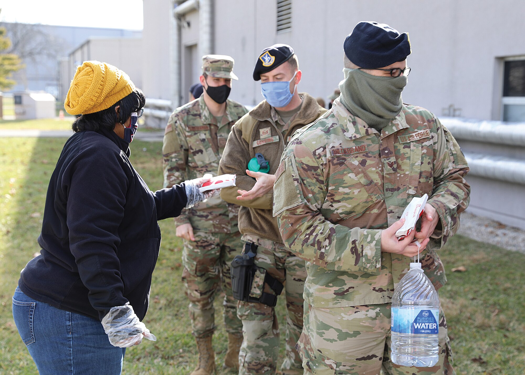 Karen Hunt, Wright-Patterson United Service Organizations (USO) volunteer, passes out chicken sandwiches to members of the 445th Airlift Wing Jan 9., 2021.