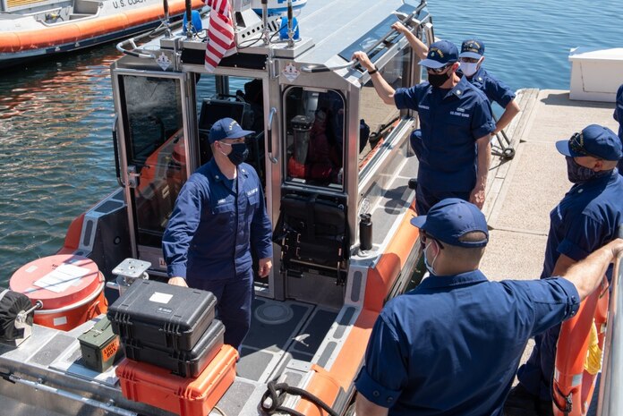 Petty Officer 2nd Class Andrew Chaney, a boatswain's mate at Coast Guard Station Burlington, reviews boating equipment with the new reserve boarding teams at Station Burlington, Vt., June 16, 2020. Reservists join the active duty crewmembers during the busy summer season to support law enforcement missions by providing two additional boarding teams. With the aid of the reservists, the crewmembers of Station Burlington can focus on search and rescue. This year marks the fifth summer the reservists have joined the station and begins a new and fully integrated system involving one active duty crewmember for each of the two reserve boarding teams. (U.S. Coast Guard photo by Petty Officer 1st Class Amber Howie)