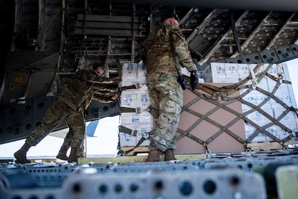 Airmen with the 502nd Logistics Readiness Squadron assist with the coordinating and unloading of more than 57,000 bottled water on a C-17 from the 16th Airlift Squadron, Joint Base Charleston, South Carolina Feb. 21 at Joint Base San Antonio-Kelly Field. The 502nd LRS assisted with the coordinating and unloading of more than 150,000 pounds of bottled water brought in via aircraft to be distributed to the city of San Antonio.
