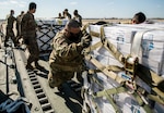 U.S. Air Force Airmen and Army Soldiers unload pallets of bottled water Feb. 21 at Joint Base San Antonio-Kelly Field. Joint Base San Antonio provided emergency response assistance to local officials and agencies in order to ensure the safety and security of the community during and after the severe winter storm.