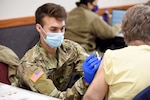 U.S. Army Spc. Lucas Tratechaud, a combat medic with 3rd Battalion, 126th Infantry Regiment, Headquarters and Headquarters Company, Michigan Army National Guard,  vaccinates a resident in Coldwater, Michigan, Feb. 18, 2021.